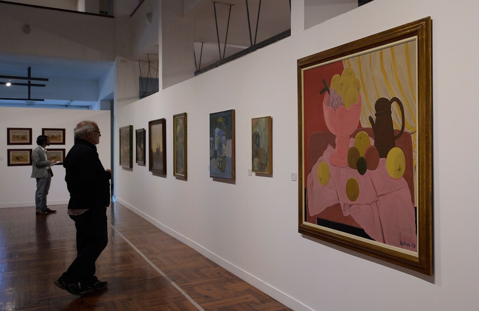 A visitor looks at a painting by Colombian artist Fernando Botero during an exhibition of painters from Uruguay, Mexico and Colombia at the Museum of Visual Arts in Montevideo on March 22, 2018. / AFP PHOTO / Miguel ROJO        (Photo credit should read MIGUEL ROJO/AFP/Getty Images)