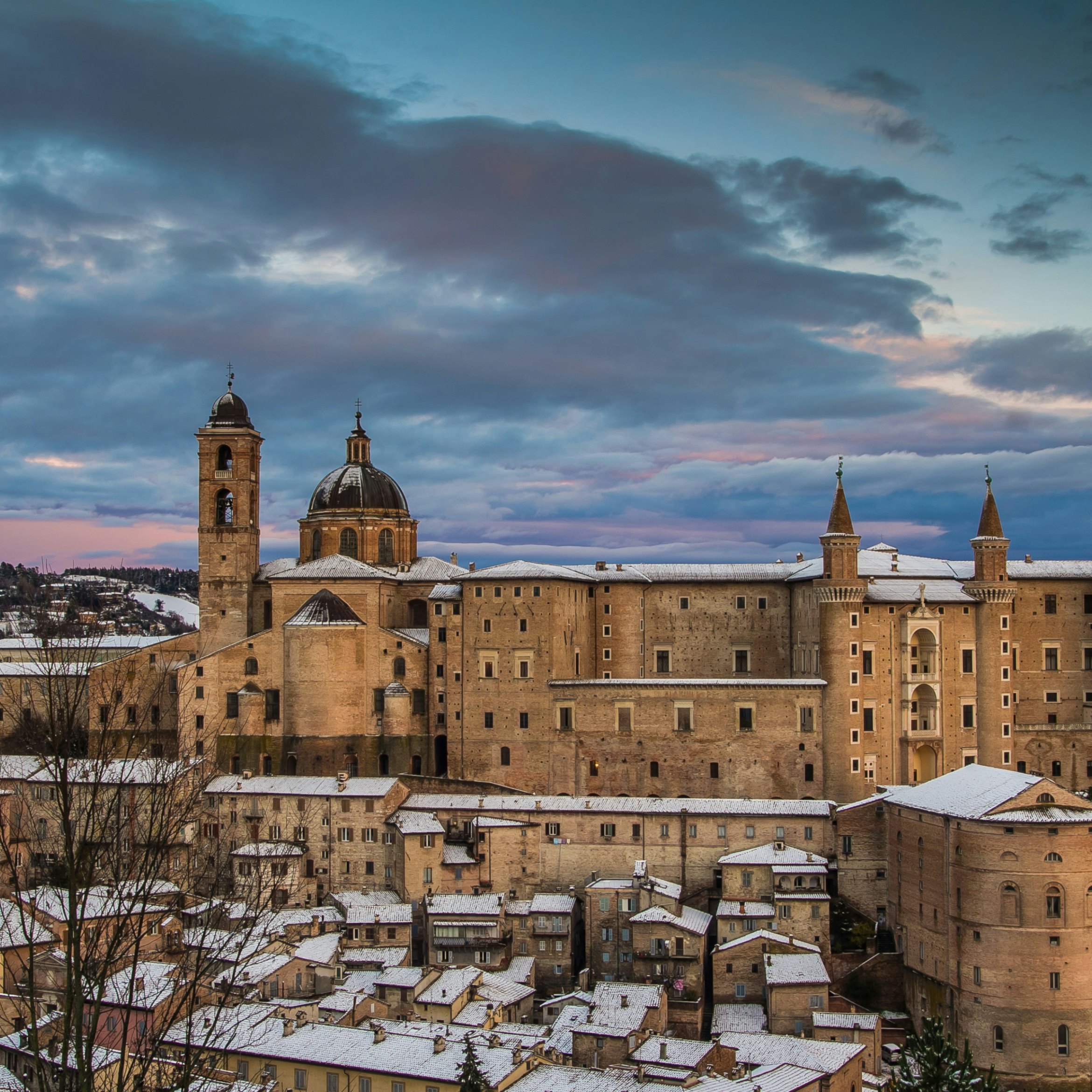 Beautiful colored sky over Urbino at sunset with snow.