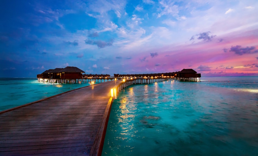 Oversea resort huts at end of long jetty, Maldives