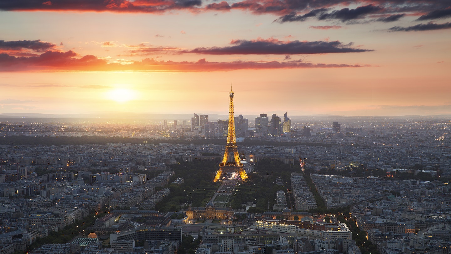 Eiffel Tower and Paris cityscape at sunset.