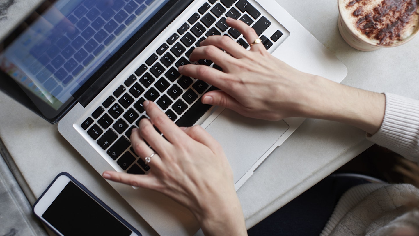 Overhead View Of Young Woman Working Remotely On Laptop