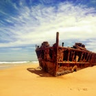 Rusted shipwreck on beach of Fraser Island.
