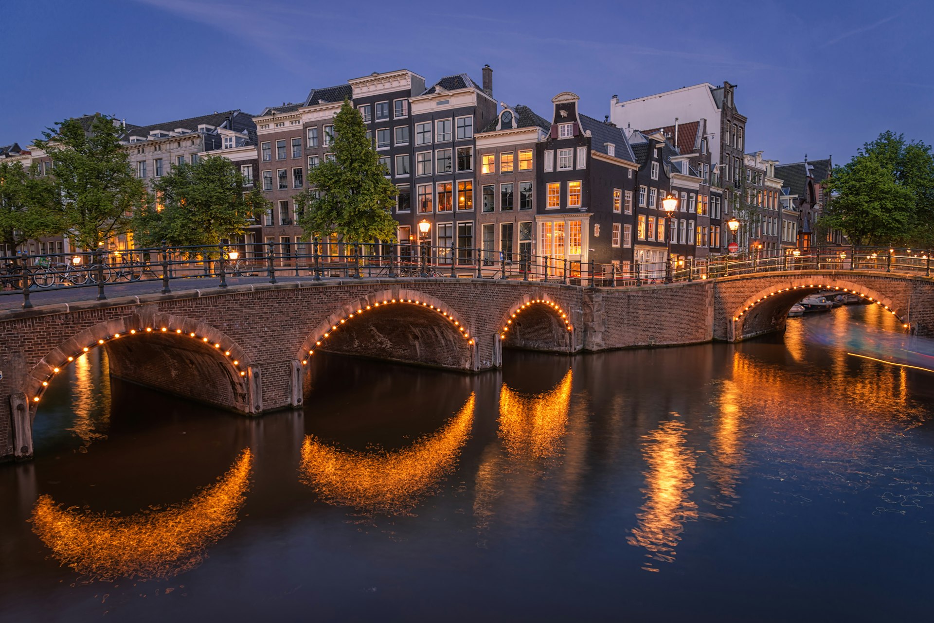 A bridge over a canal in Amsterdam at night