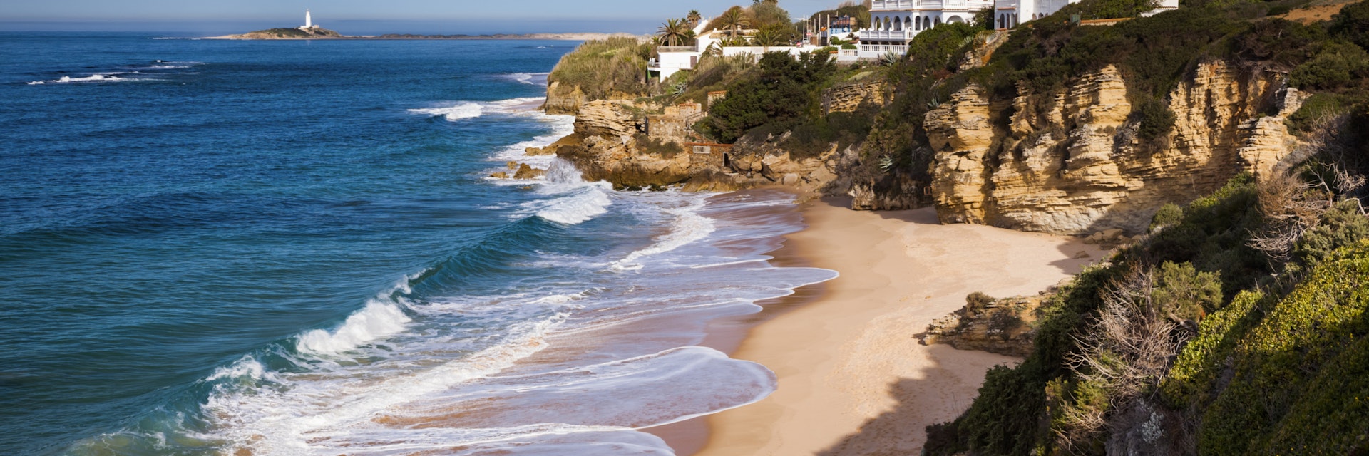 Beach at Los Canos de Meca, the lighthouse of Cape Trafalgar is visible in the distance - Costa de la Luz, Andalusia, Spain