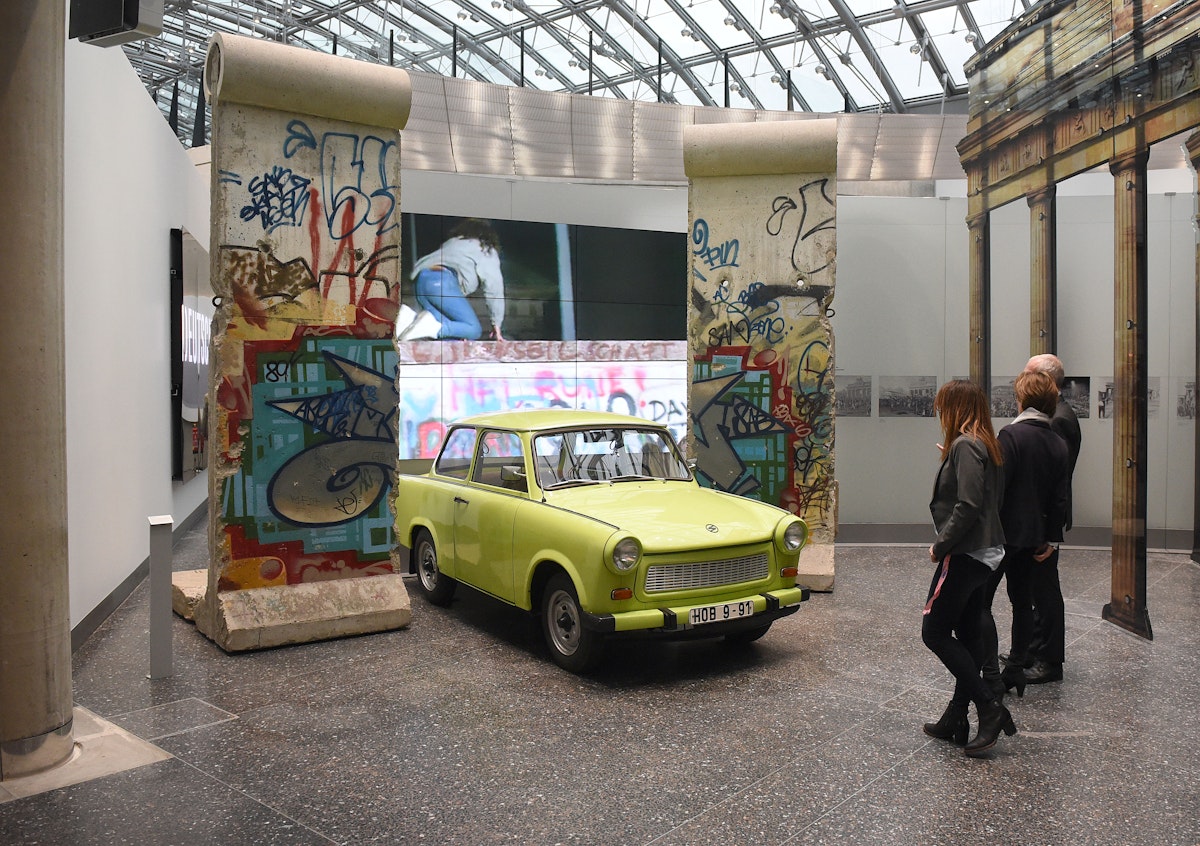 Parts of the Berlin Wall and a Traband car can be seen during the reopening of the permanent exhibition at the 'Haus der Geschichte' (lit. 'House of History' in Bonn, Germany, 11 December 2017. Photo: Henning Kaiser/dpa (Photo by Henning Kaiser/picture alliance via Getty Images)