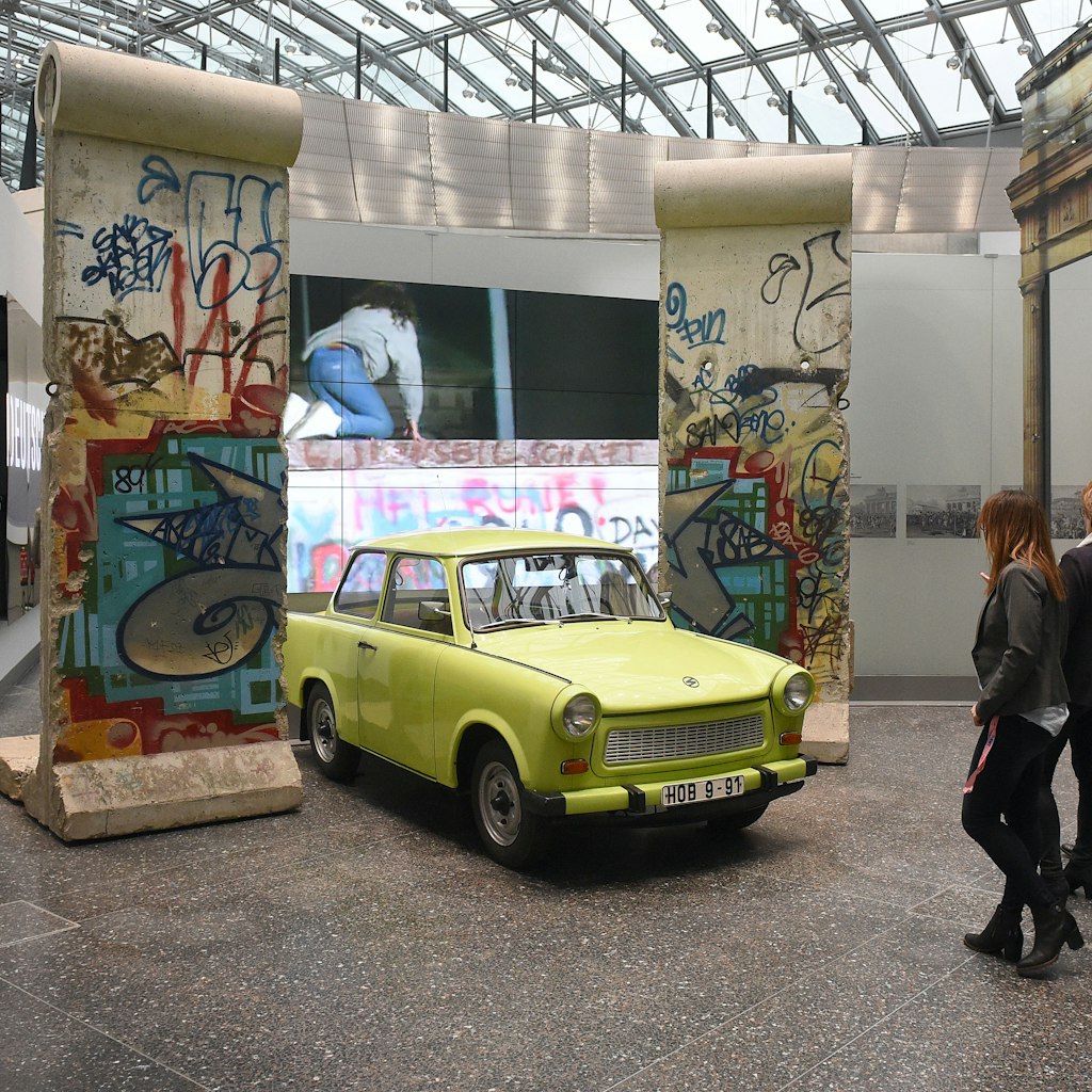 Parts of the Berlin Wall and a Traband car can be seen during the reopening of the permanent exhibition at the 'Haus der Geschichte' (lit. 'House of History' in Bonn, Germany, 11 December 2017. Photo: Henning Kaiser/dpa (Photo by Henning Kaiser/picture alliance via Getty Images)