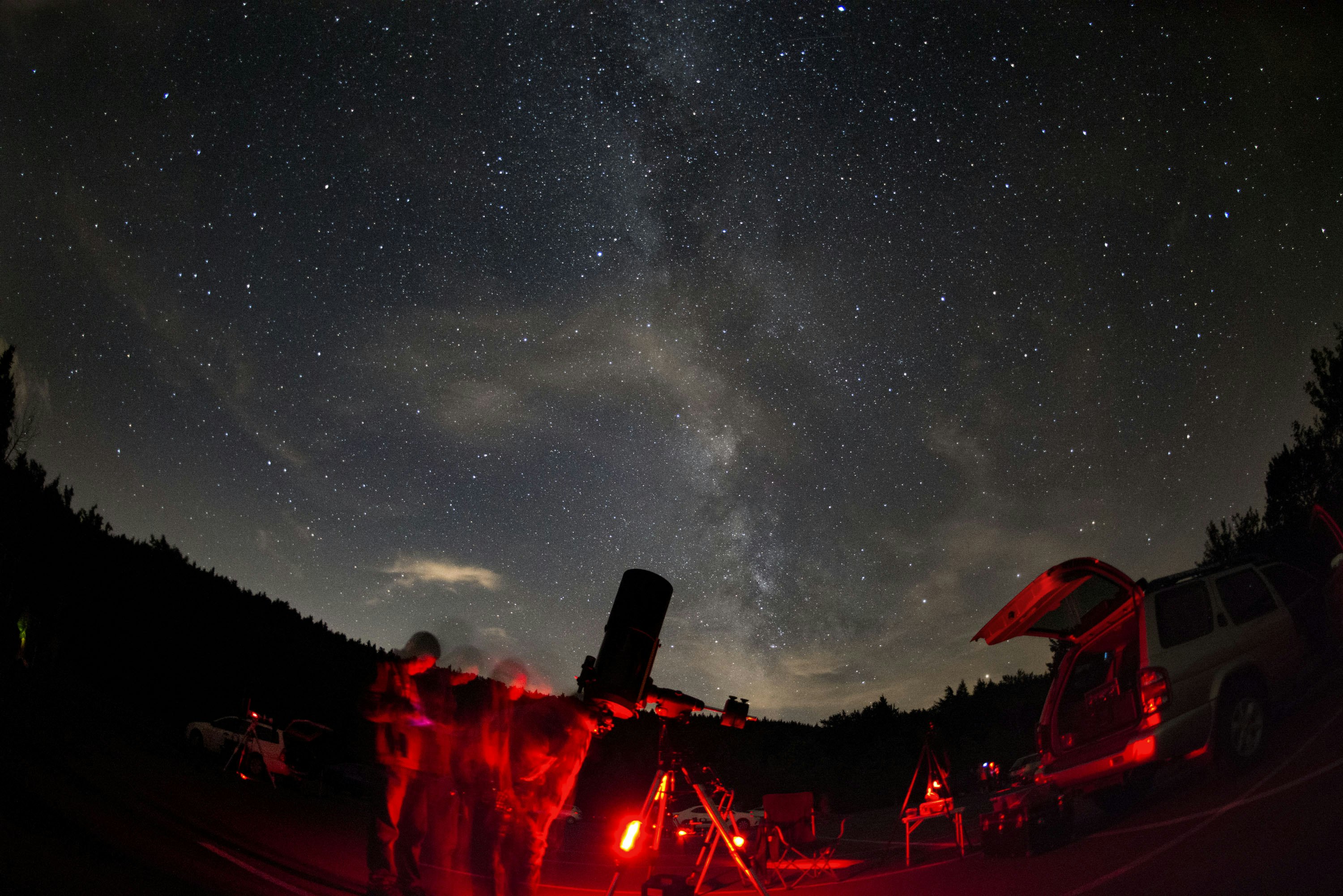 An Amateur Astronomers Association of New York stargazing event, lit with red lights
