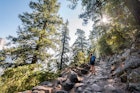 A woman hiking on a rocky trail on the John Muir Trail.