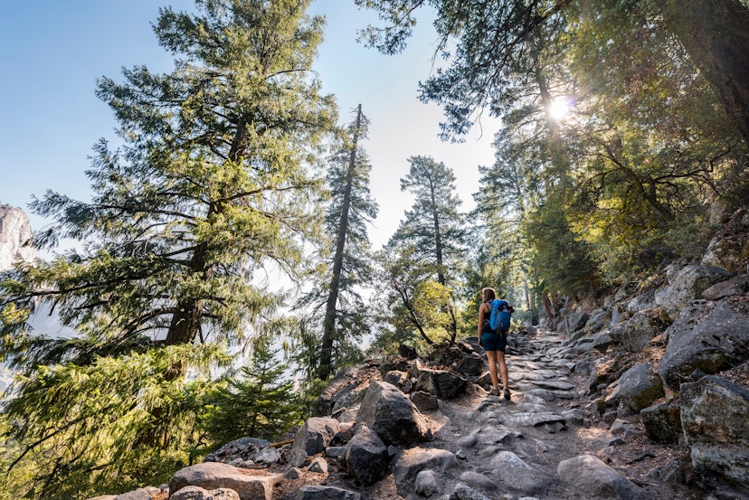 A woman hiking on a rocky trail on the John Muir Trail.