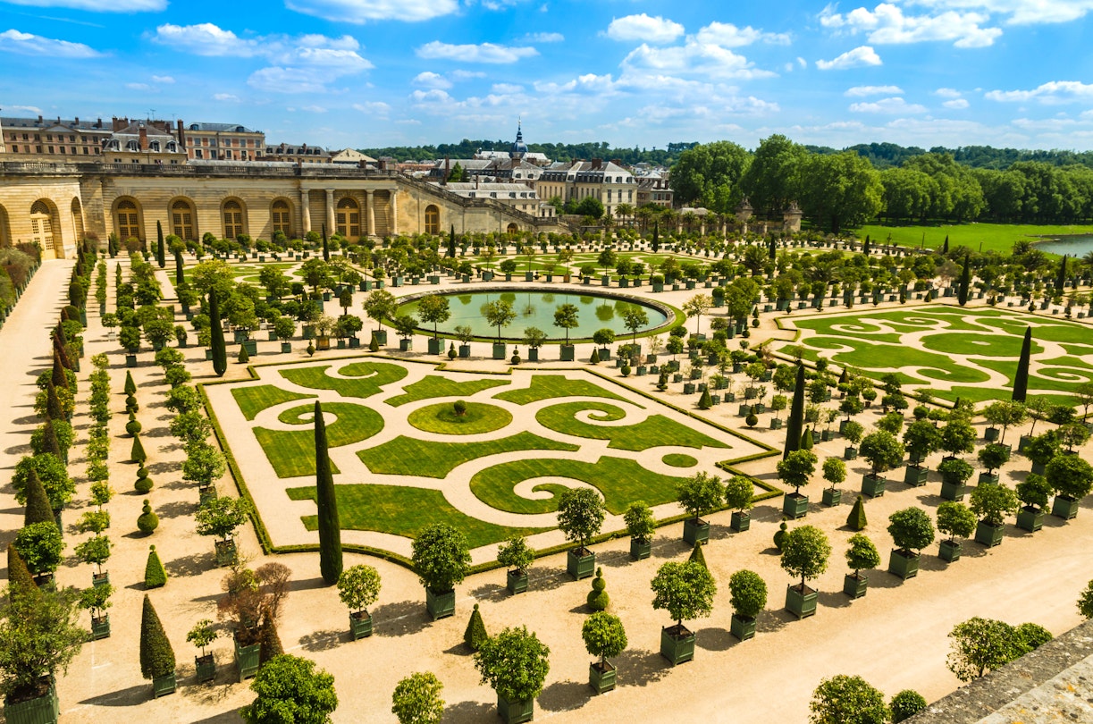 High-angle view of the manicured gardens of Versailles Palace.