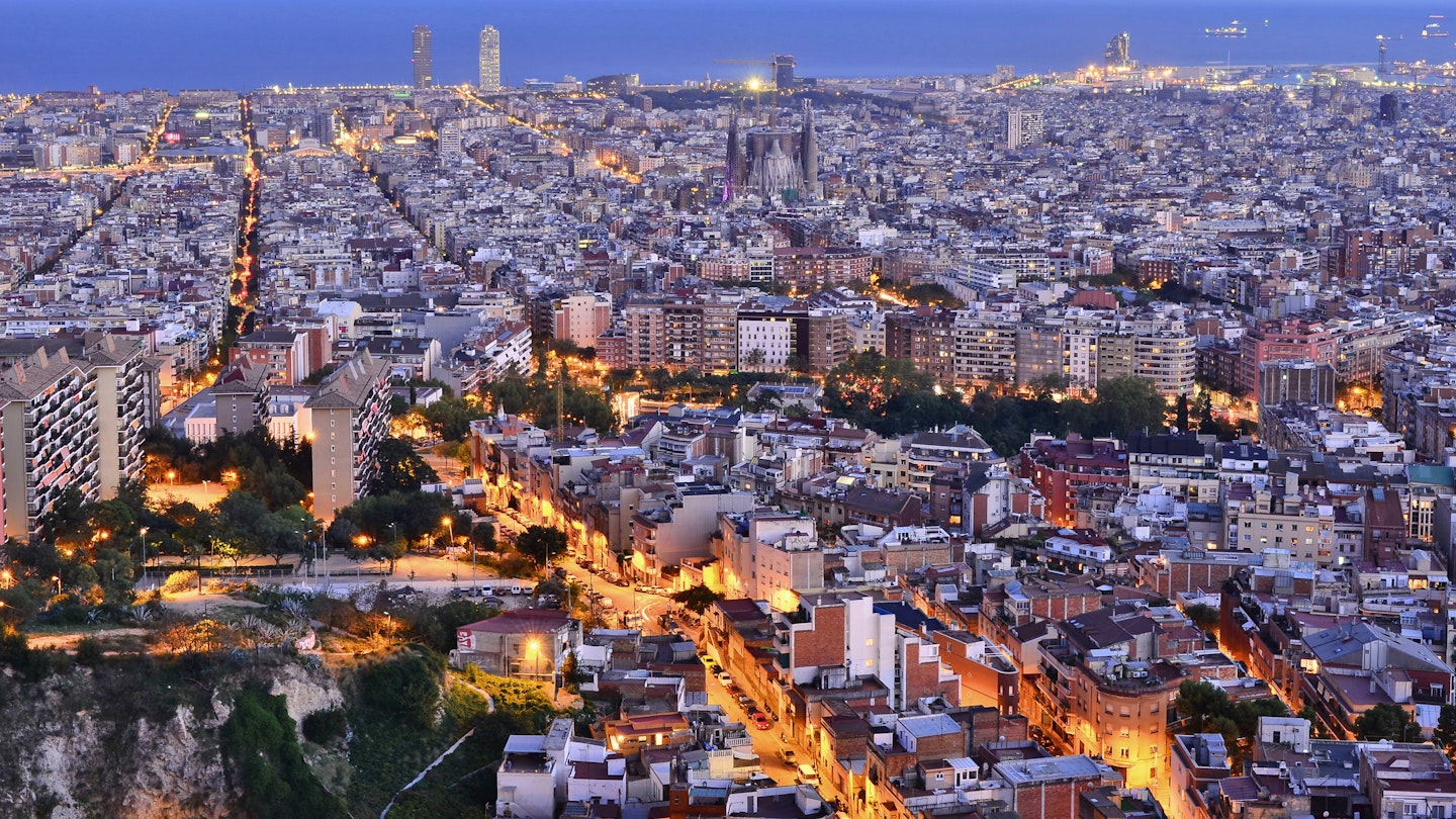 City of Barcelona illuminated at dusk elevated view from Turo de la Rovira hill in Catalonia Spain Europe.