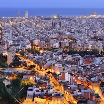 City of Barcelona illuminated at dusk elevated view from Turo de la Rovira hill in Catalonia Spain Europe.