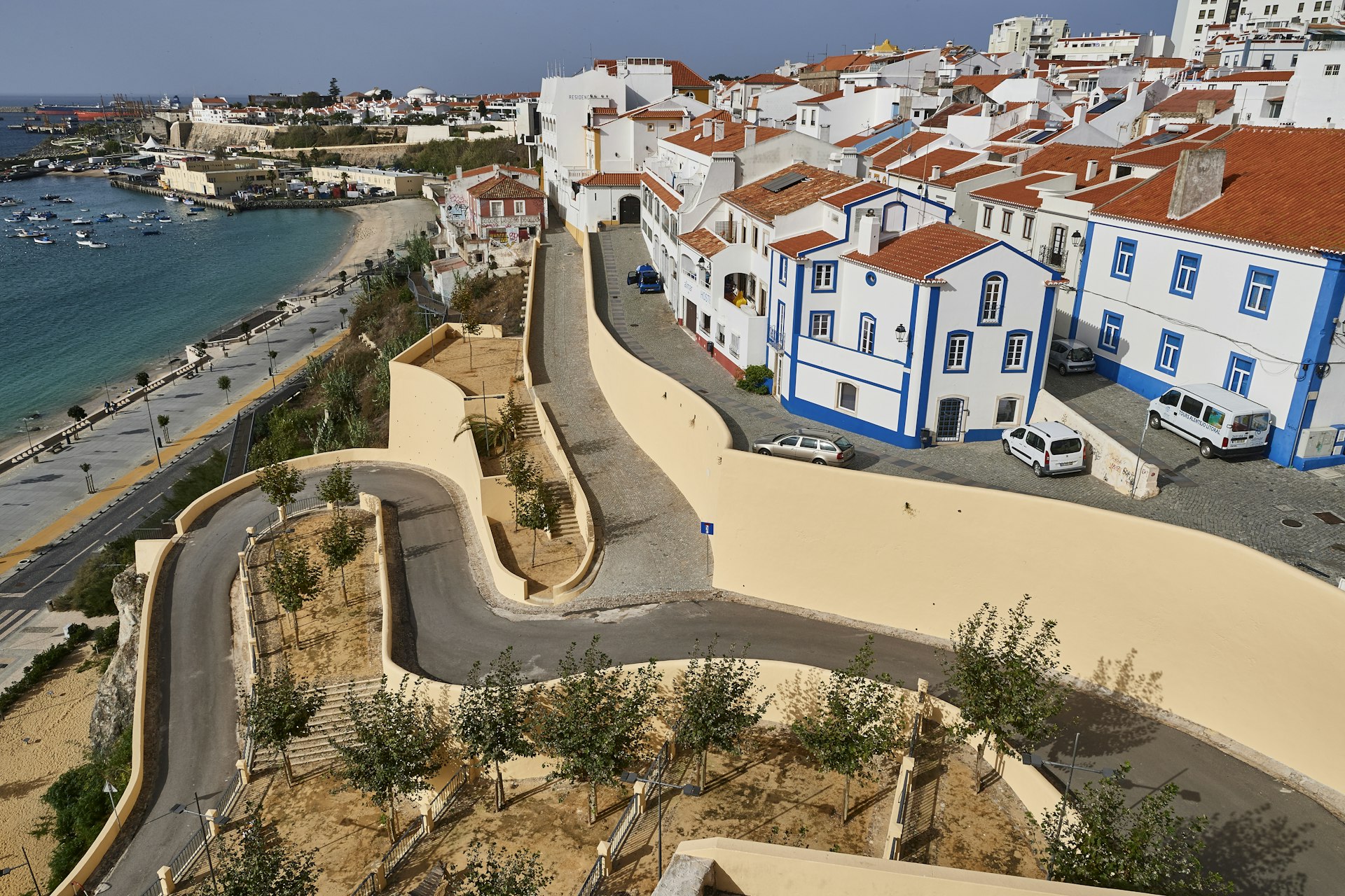 Blue and white houses at the top of winding hill in Sines village in Alentejo, Portugal