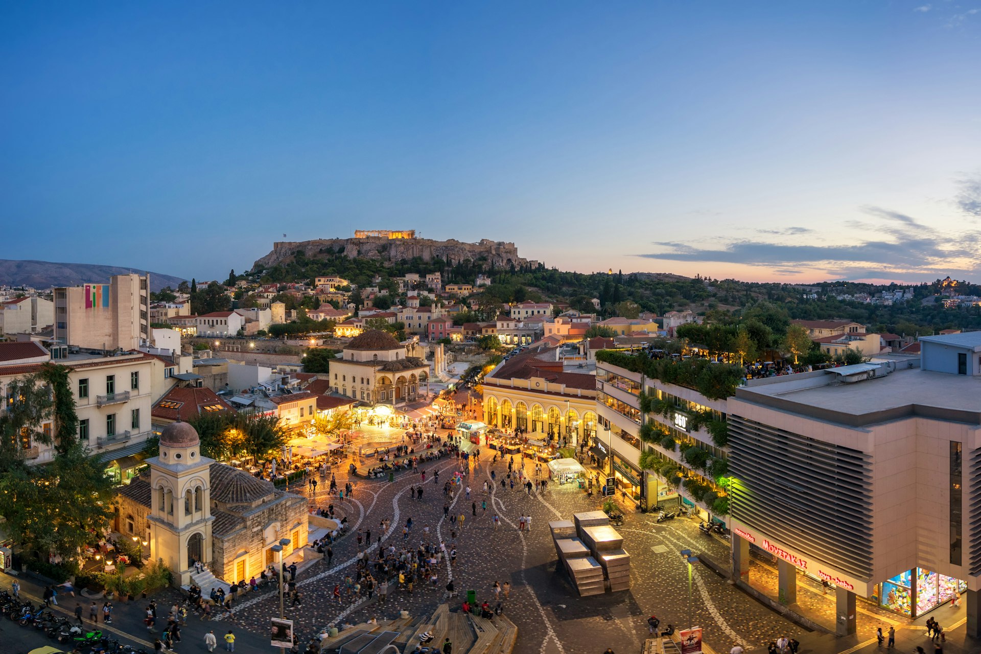 Aerial view people walking around Monastiraki Square and Acropolis of Athens, Greece 
