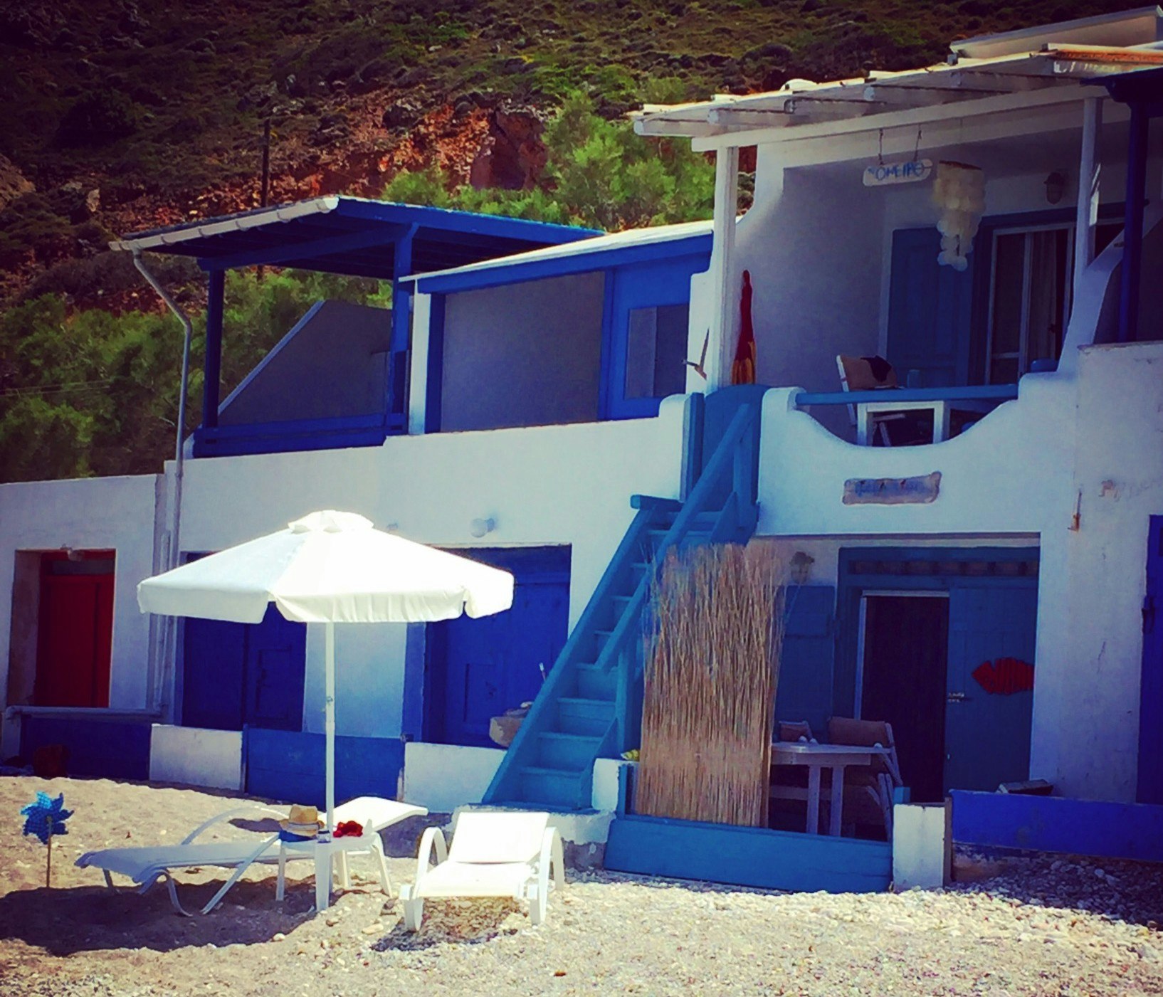 A blue beach bungalow in Milos, Greece