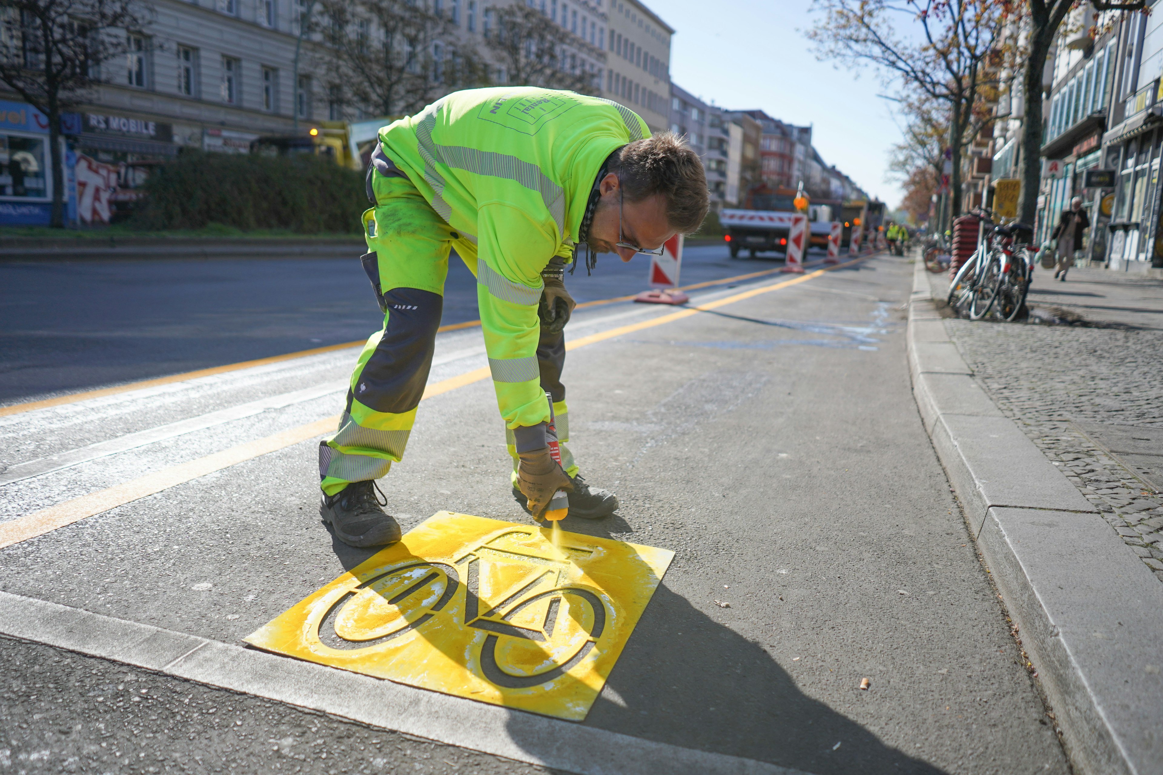 A man marks a temporary cycle lane on the Kottbusser Damm