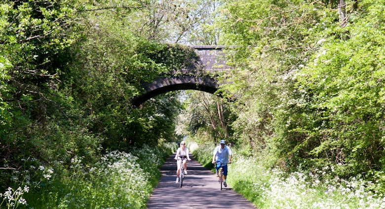 Bath, England - May 22, 2012: A couple cycling on the Bristol and Bath Railway Path in spring.