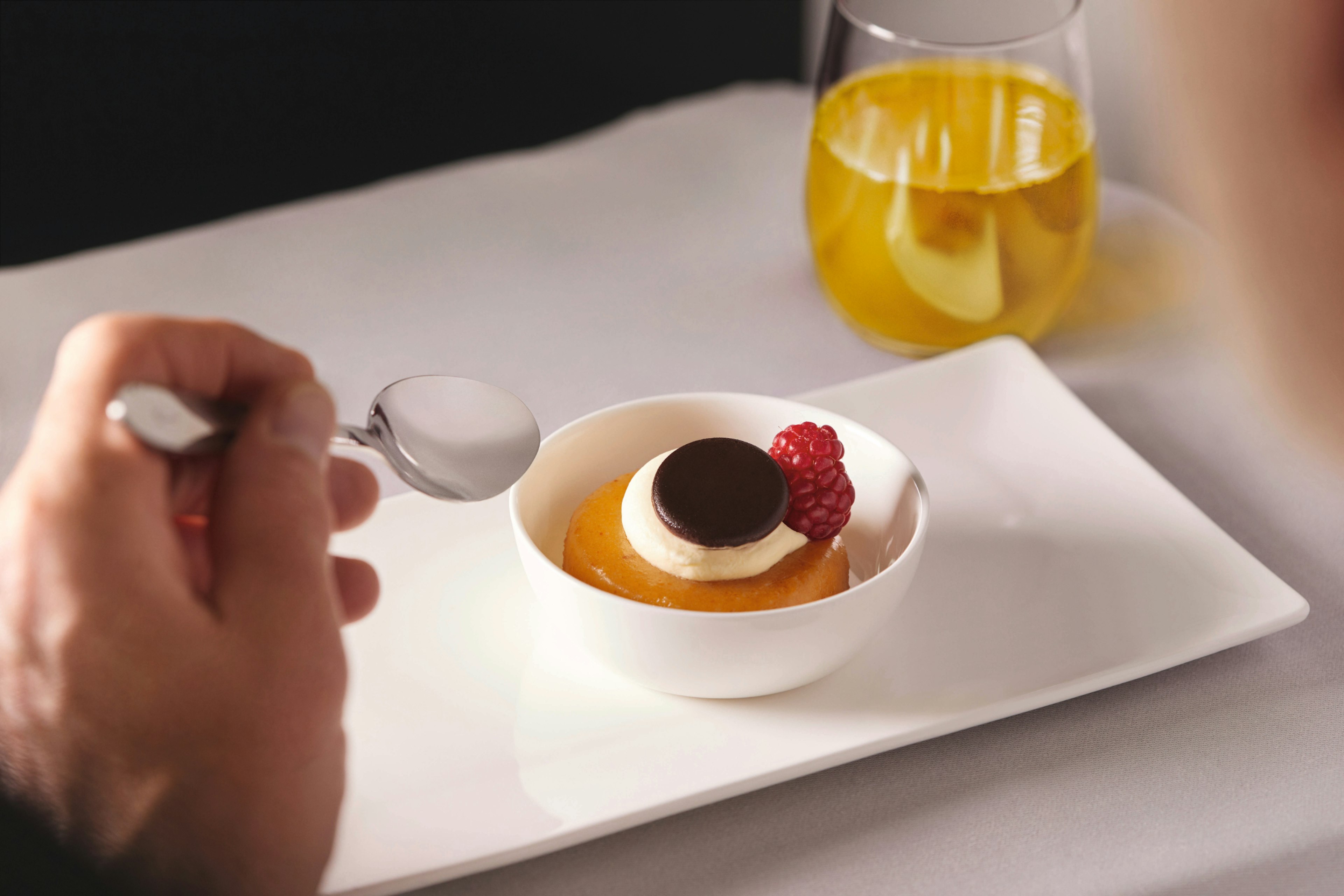 Someone eatinga dessert in first call on British Airways