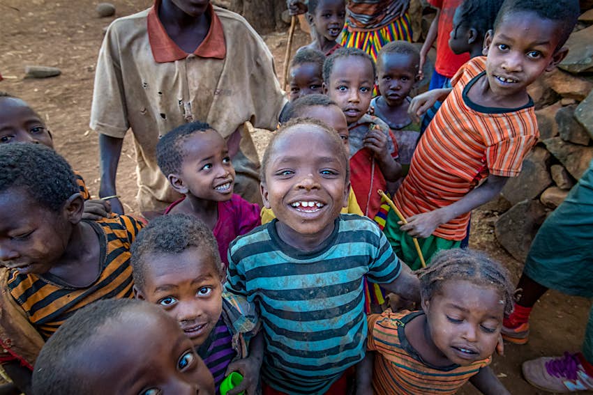 A group of Ethiopian children smile up at the camera