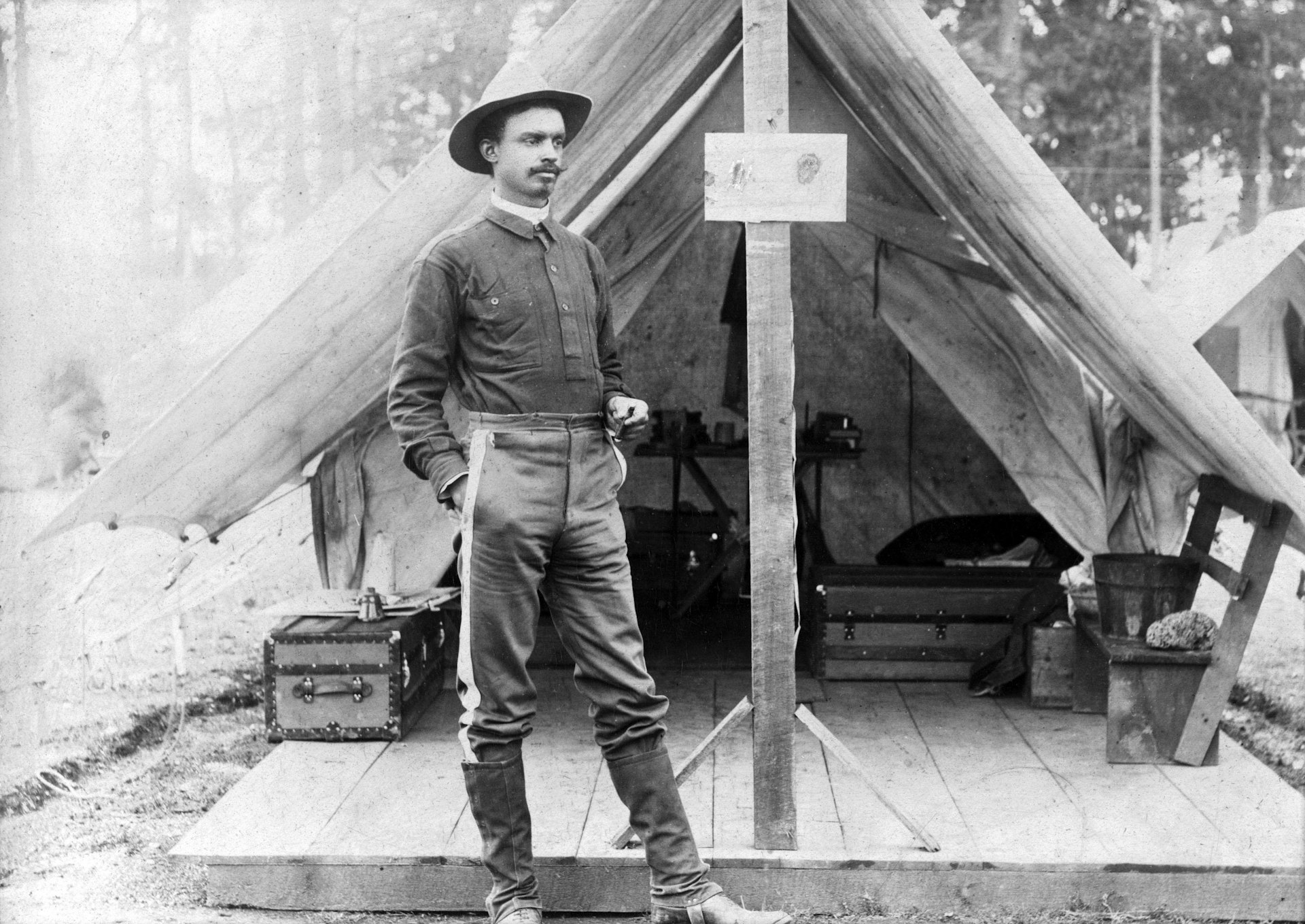 Buffalo soldier. T.R. Clarke, 8th US Volunteer Infantry, standing in front of tent, during the Spanish-American War. ca. 1898