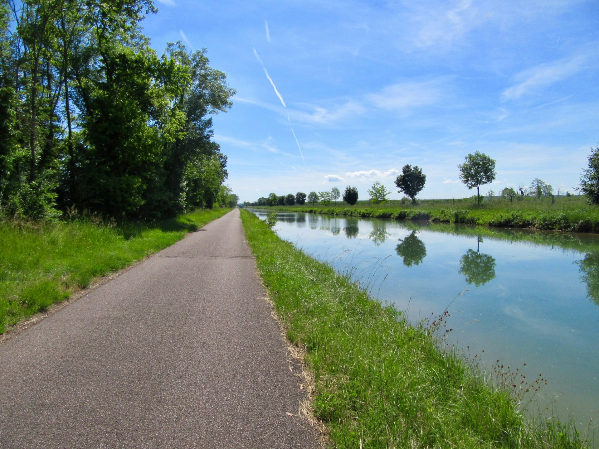 An empty cycling path by the side of a canal
