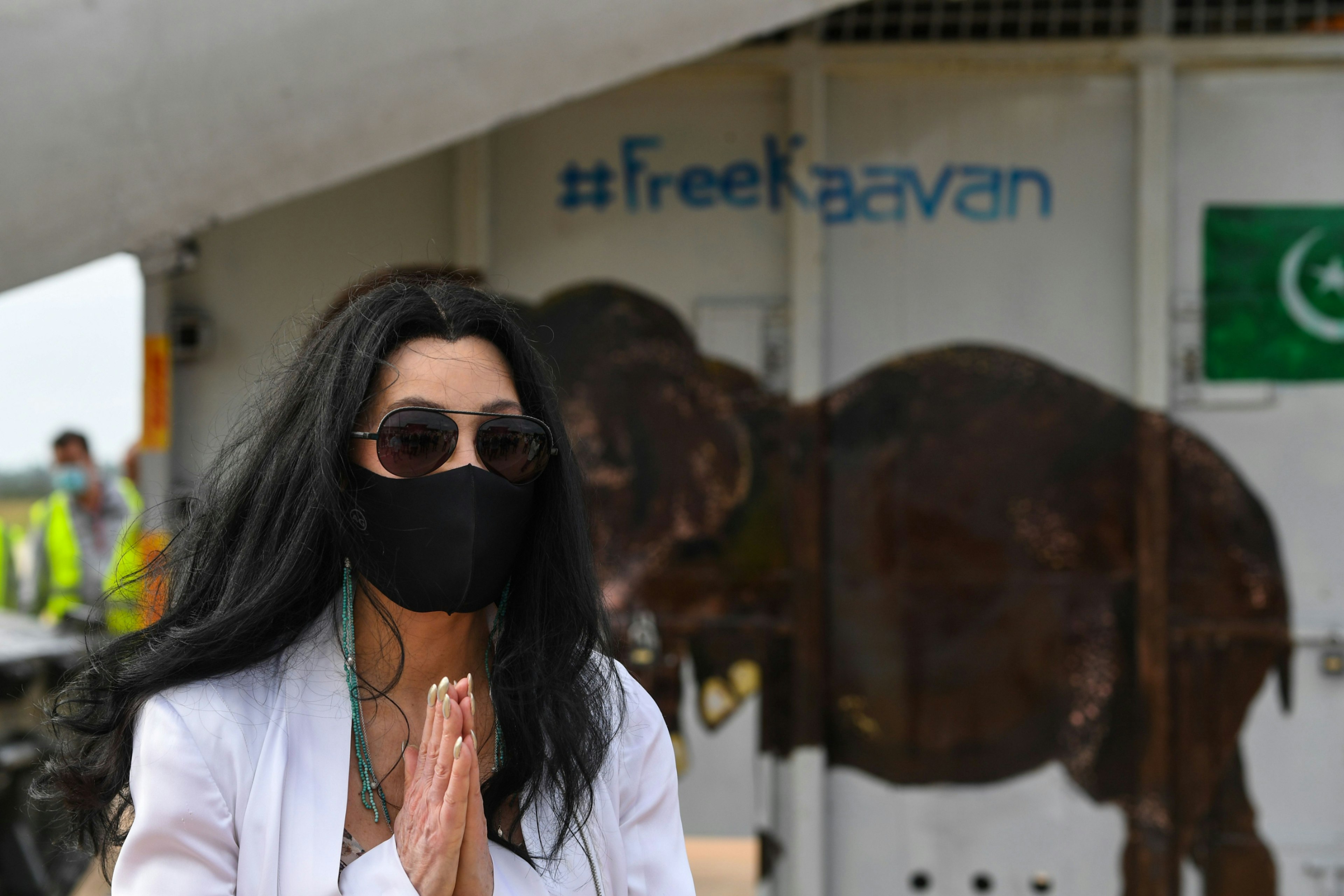 Singer Cher gestures in front of the crate of Kaavan the Asian elephant upon his arrival in Cambodia from Pakistan