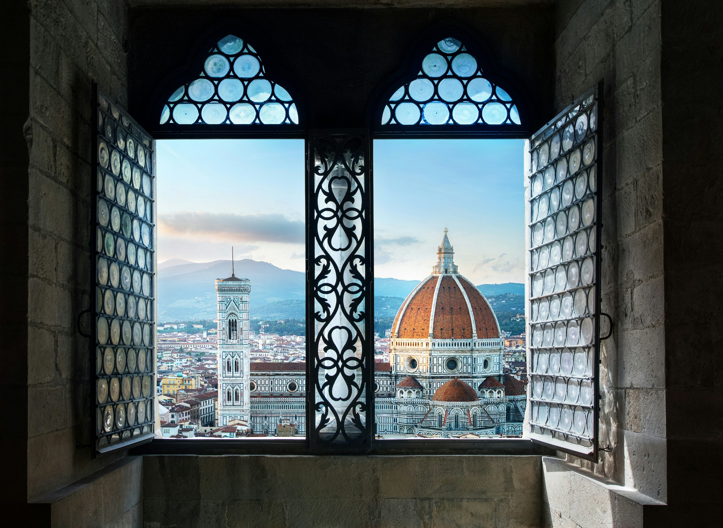 A view of the iconic red Duomo through the window of a Florentine home