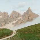 Orla Thomas and guide Narciso Simion walking near Pale di San Martino