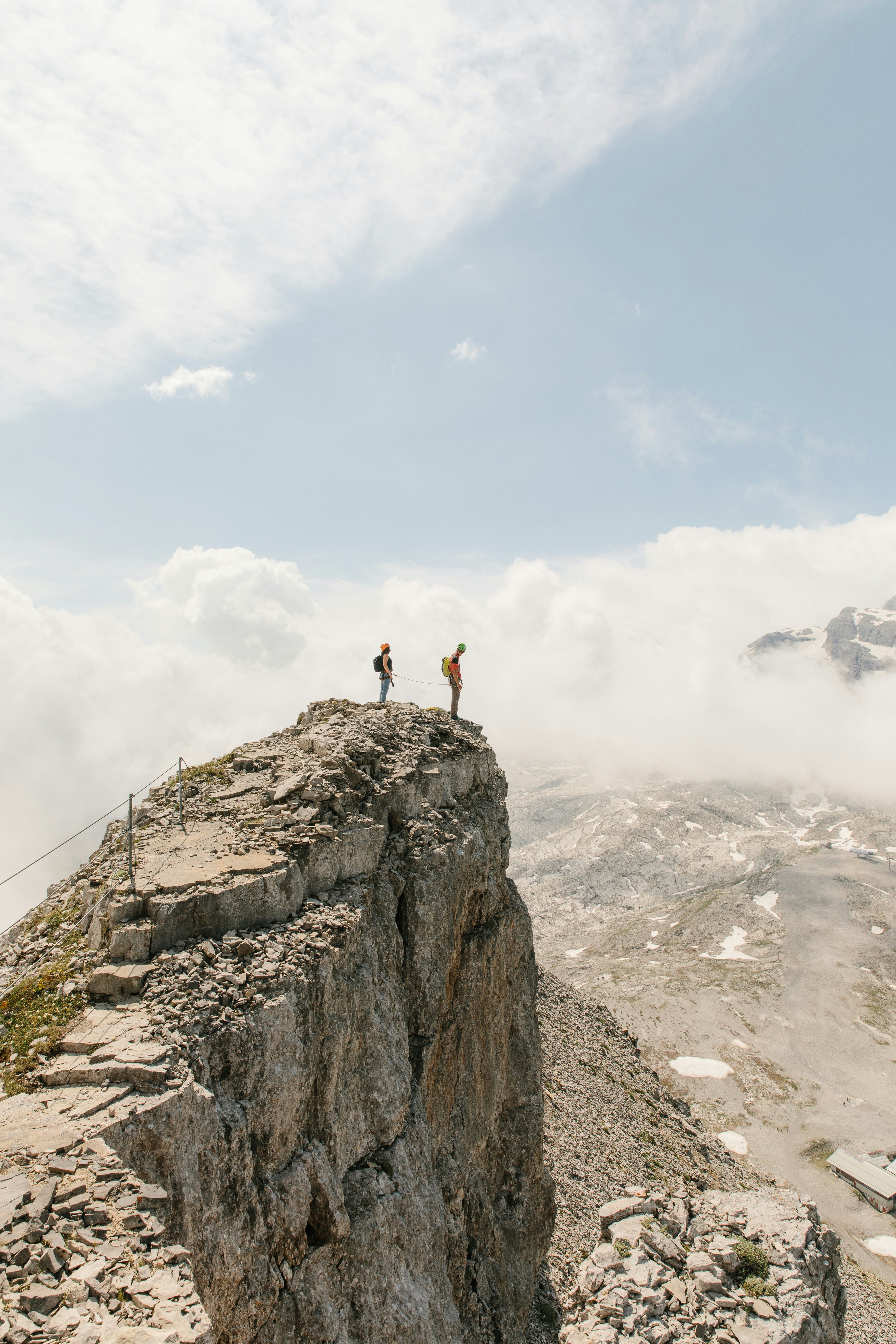 A man and woman stand at the edge of a cliff