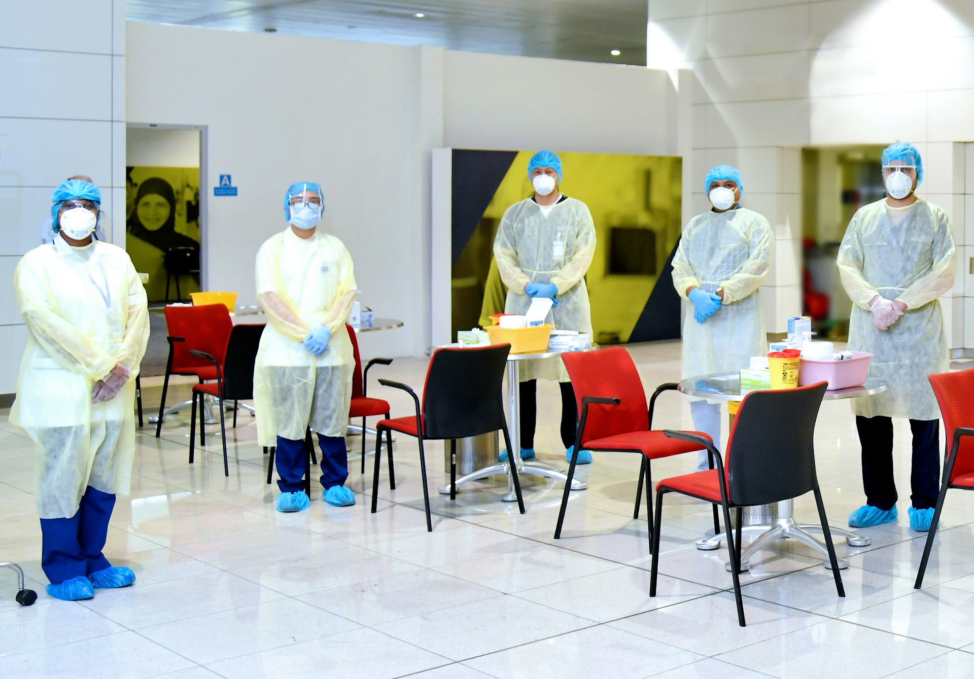 Dubai medical professionals pose in the airport wearing PPE