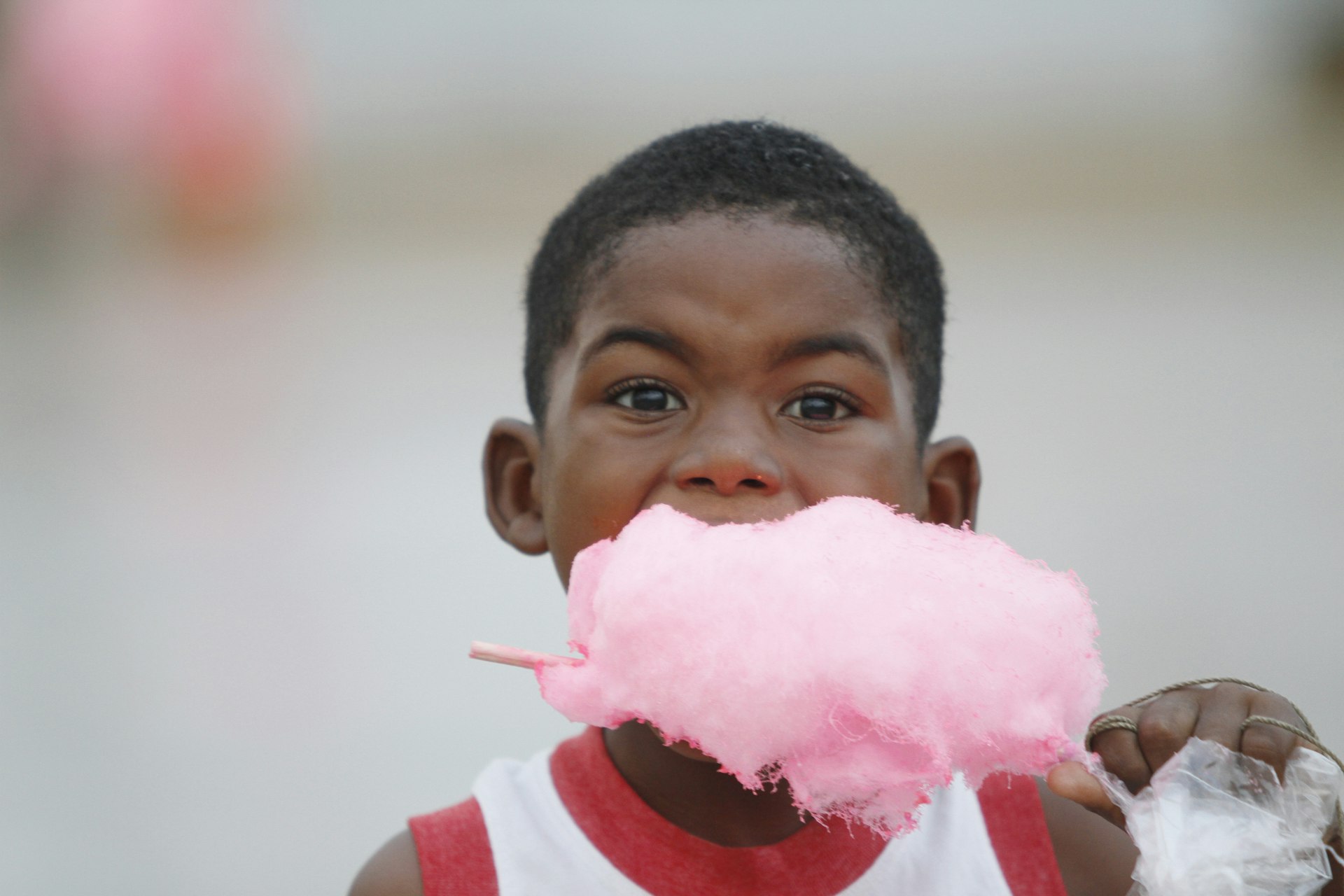  A child enjoys cotton candy in Esmeraldas, Ecuador,