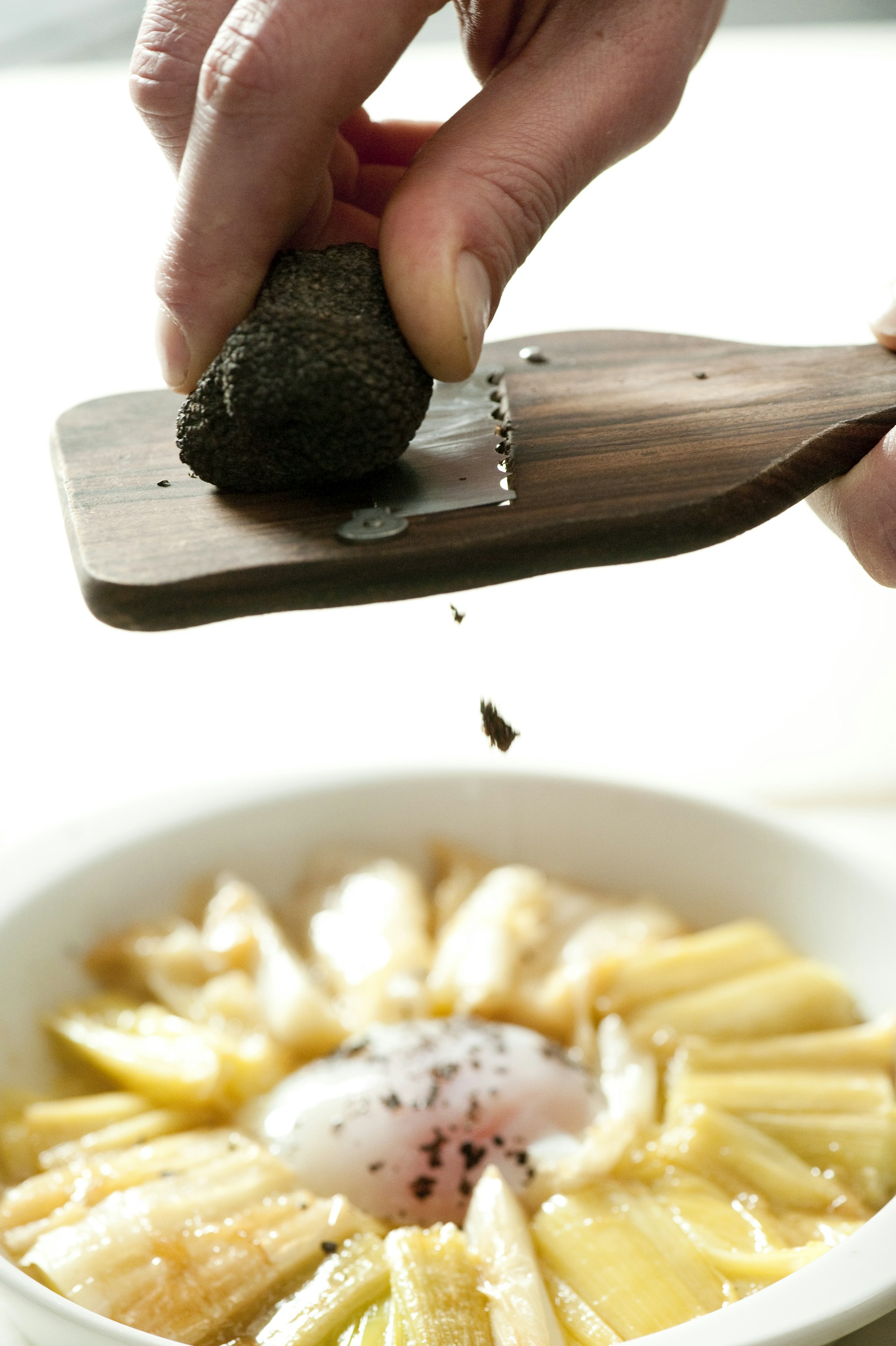 shaving black truffle over braised leeks, poached eggs & black truffle cocotte ©Susan Wright/Lonely Planet