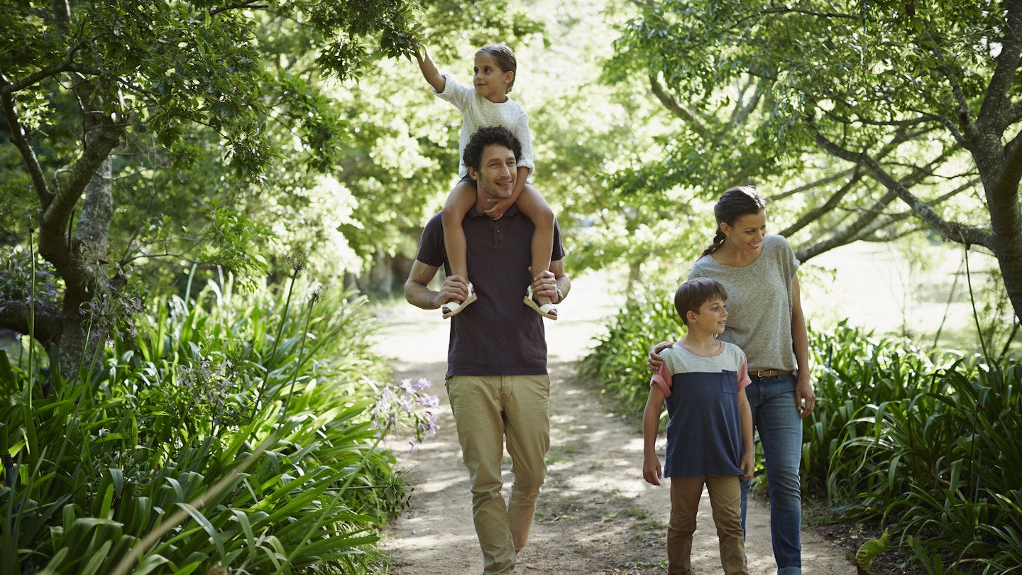 Full length of two generation family walking on path in park