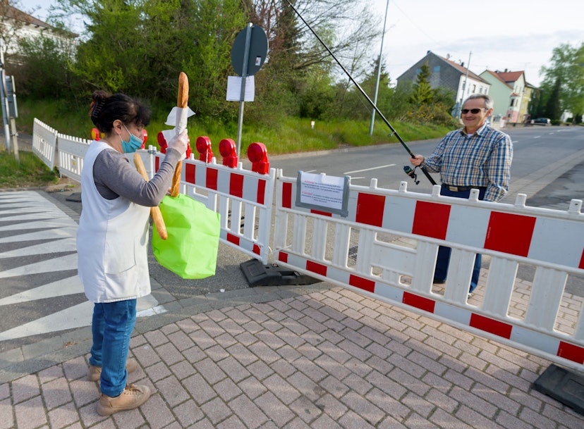 Hartmut Fey, a German citizen of Lauterbach, gets his French baguettes at the German-French border using his fisher rod to avoid a penalty of 250 on April 18, 2020 in Carling, eastern France, on the 33rd day of a lockdown in France aimed at curbing the spread of the COVID-19 infection caused by the novel coronavirus. (Photo by JEAN-CHRISTOPHE VERHAEGEN / AFP) (Photo by JEAN-CHRISTOPHE VERHAEGEN/AFP via Getty Images)