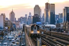 7 Line Subway train in Queens with Manhattan skyline, New York City
