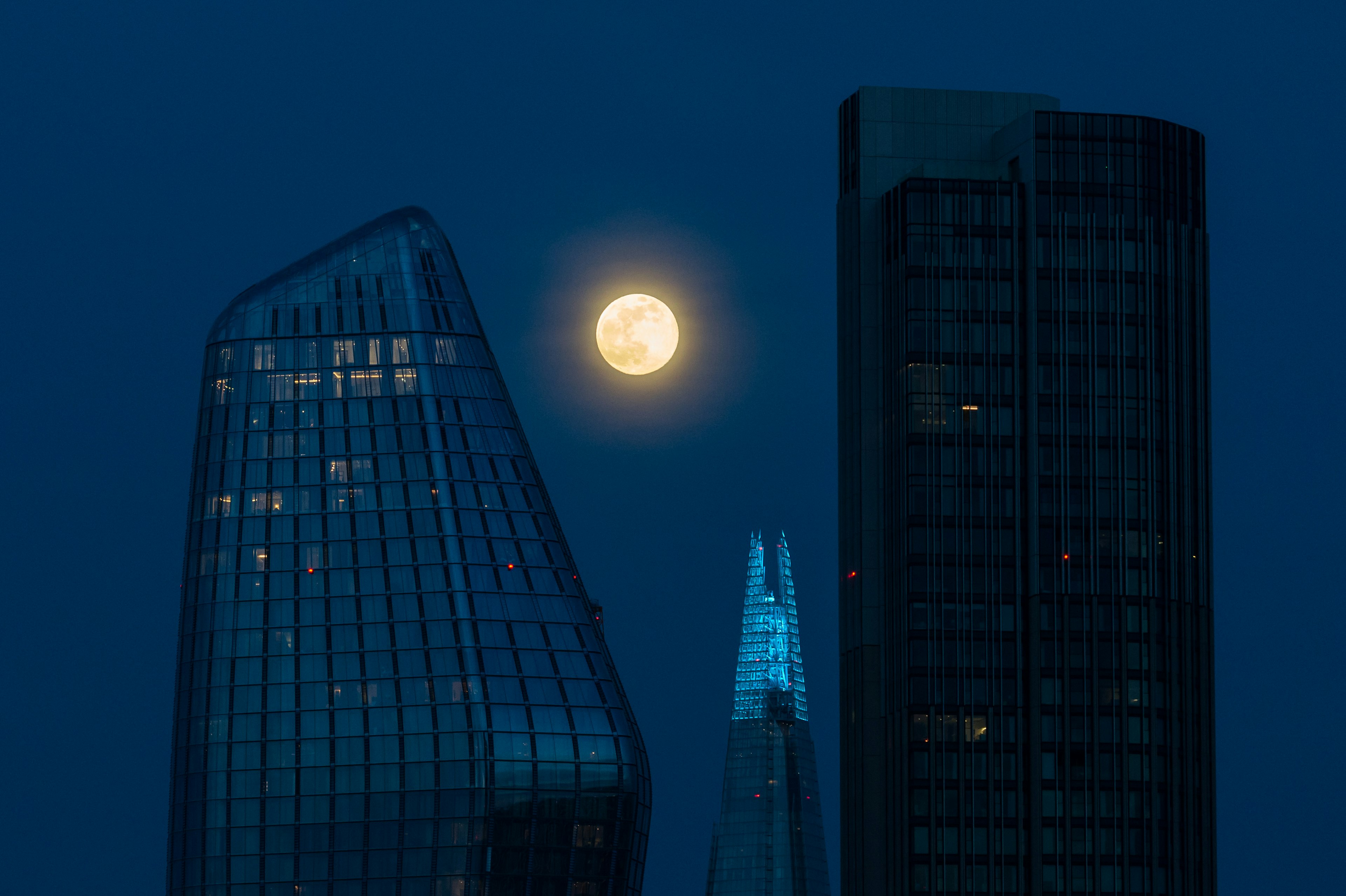 A large moon shines over London.