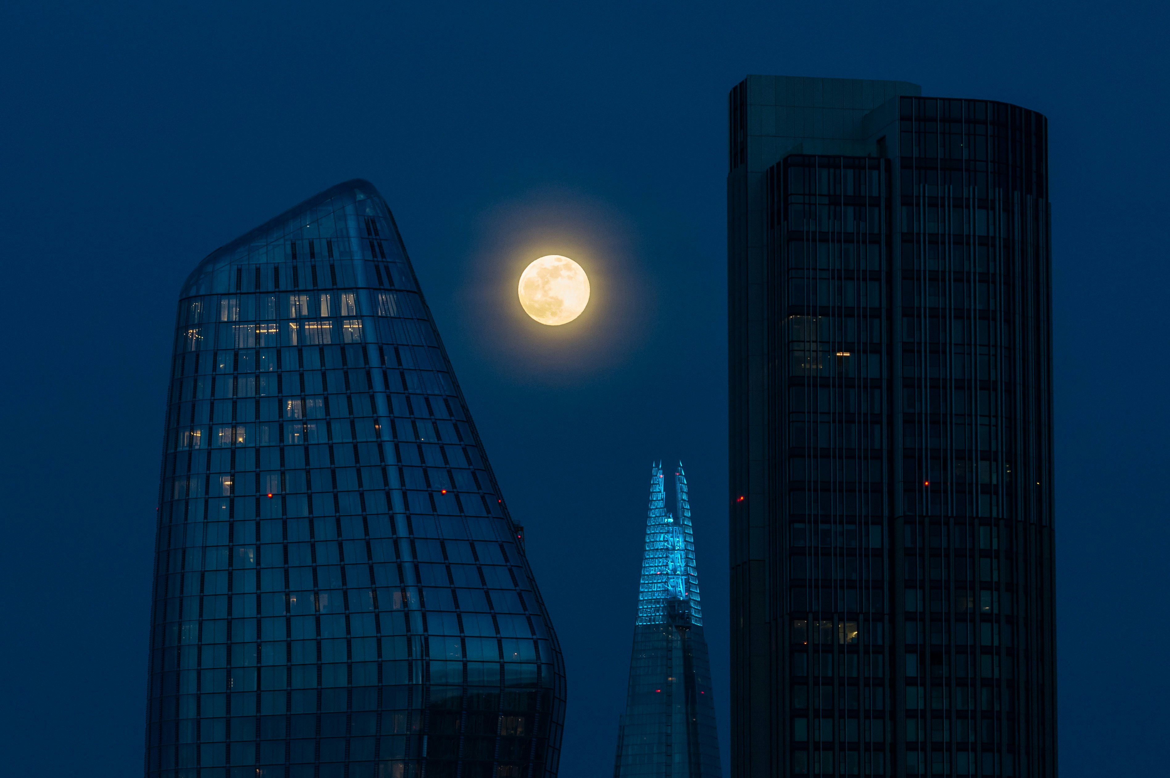A large moon shines over London.
