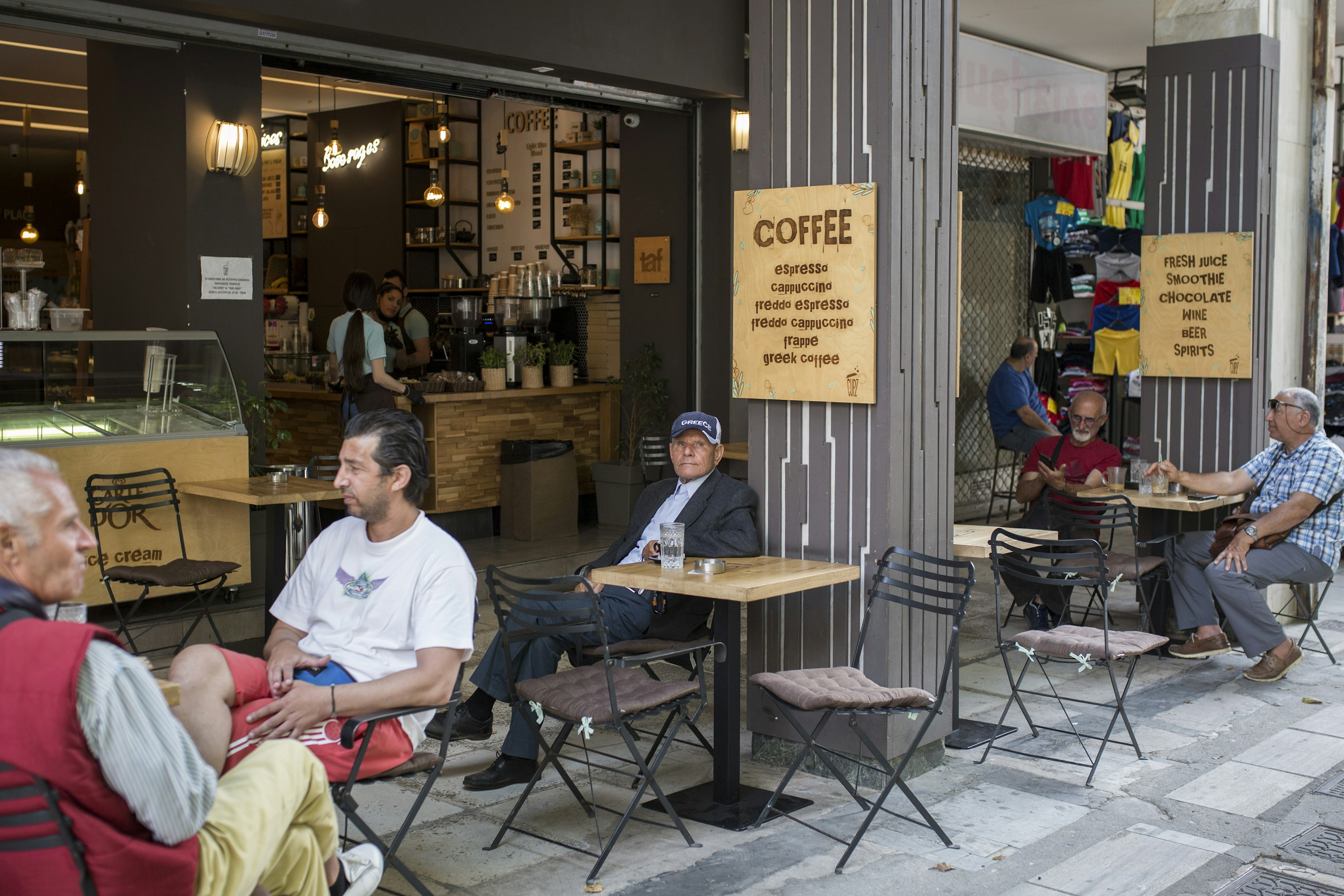 Guests sit in a cafe in Athens