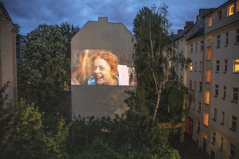 BERLIN, GERMANY - APRIL 30: The movie is projected from the home on the backyard firewall of residential building on April 30, 2020 in Berlin, Germany. The project "Windowflicks" is hosting film screenings to Berlin's courtyards, as cinemas are closed during Coronavirus (Covid-19) crisis. The organizers are currently offering these screenings for free as a symbol of solidarity and support for the many endangered arthouse cinemas in Berlin. (Photo by Maja Hitij/Getty Images)