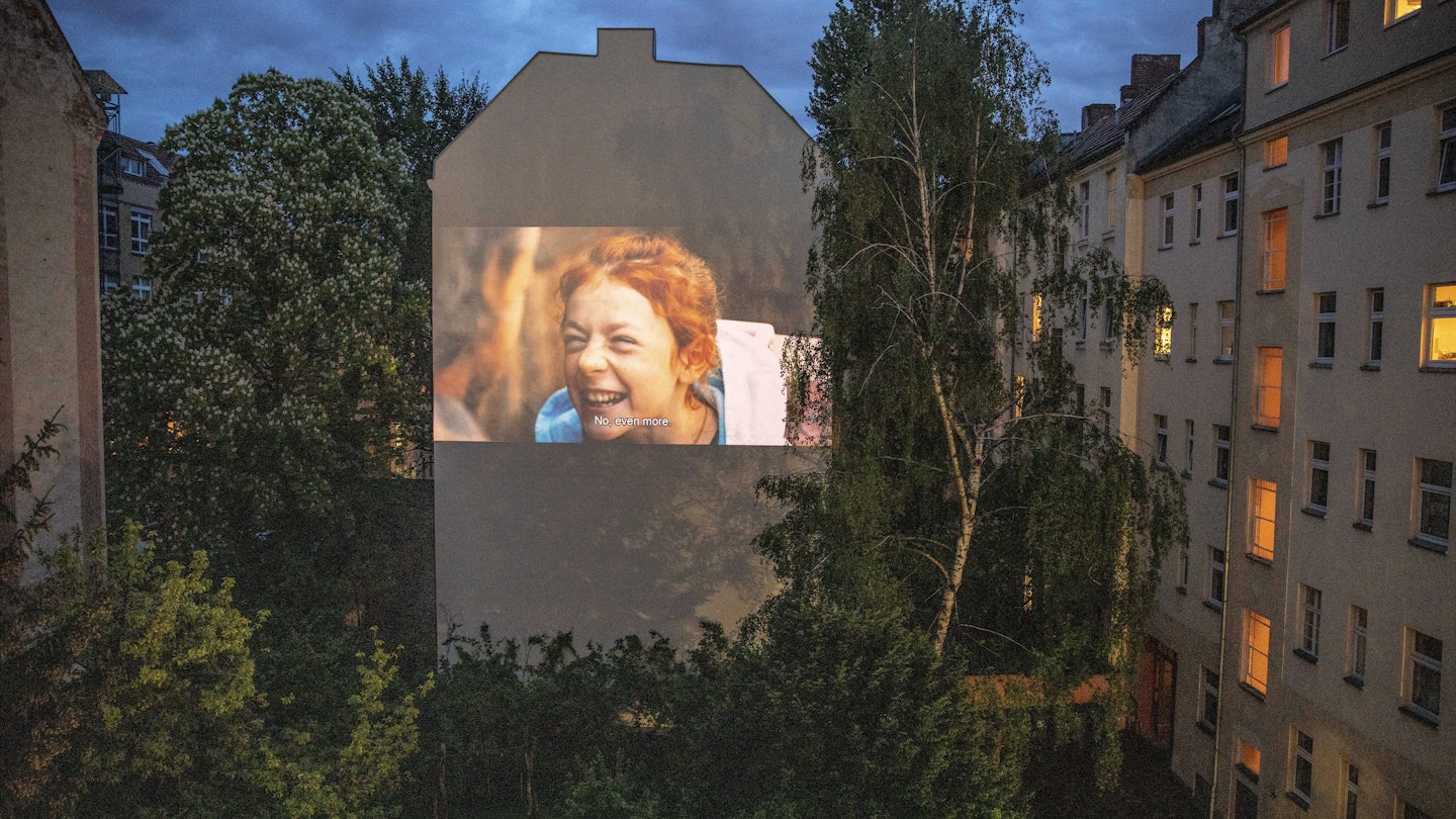 BERLIN, GERMANY - APRIL 30: The movie is projected from the home on the backyard firewall of residential building on April 30, 2020 in Berlin, Germany. The project "Windowflicks" is hosting film screenings to Berlin's courtyards, as cinemas are closed during Coronavirus (Covid-19) crisis. The organizers are currently offering these screenings for free as a symbol of solidarity and support for the many endangered arthouse cinemas in Berlin. (Photo by Maja Hitij/Getty Images)