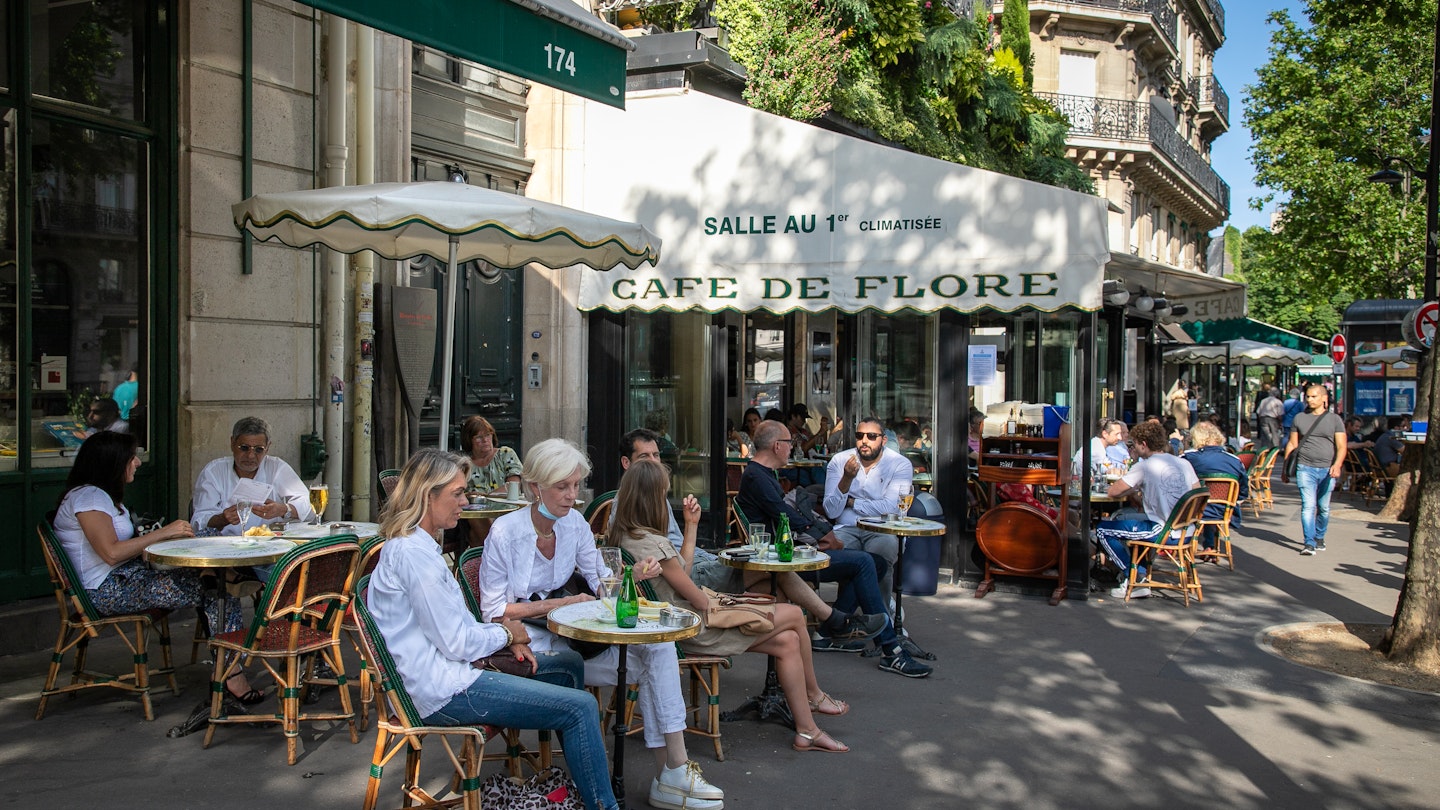 PARIS, FRANCE - JUNE 02: People have drinks at the terrace of 'Cafe de Flore' in the Latin Quarter district as bars and restaurants reopen after two months of nationwide restrictions due to the coronavirus outbreak on June 02, 2020 in Paris, France. The Coronavirus (COVID-19) pandemic has spread to many countries across the world, claiming over 376,000 lives and infecting over 6,2 million people. (Photo by Marc Piasecki/Getty Images)