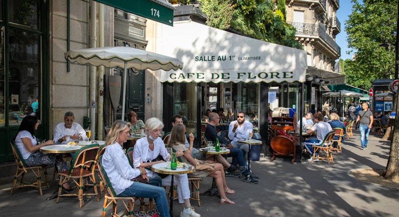 PARIS, FRANCE - JUNE 02: People have drinks at the terrace of 'Cafe de Flore' in the Latin Quarter district as bars and restaurants reopen after two months of nationwide restrictions due to the coronavirus outbreak on June 02, 2020 in Paris, France. The Coronavirus (COVID-19) pandemic has spread to many countries across the world, claiming over 376,000 lives and infecting over 6,2 million people. (Photo by Marc Piasecki/Getty Images)