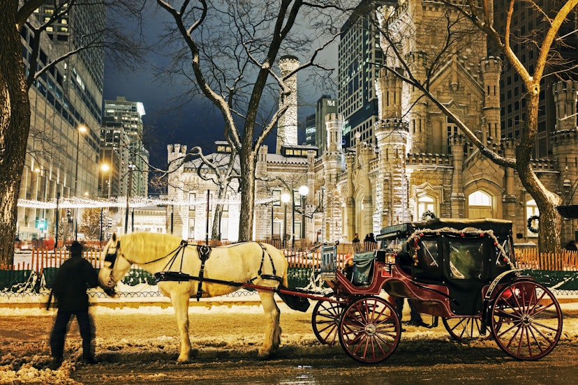 Winter in Chicago - horse carriage in front of Water Tower in Chicago. Chicago, Illinois, USA.