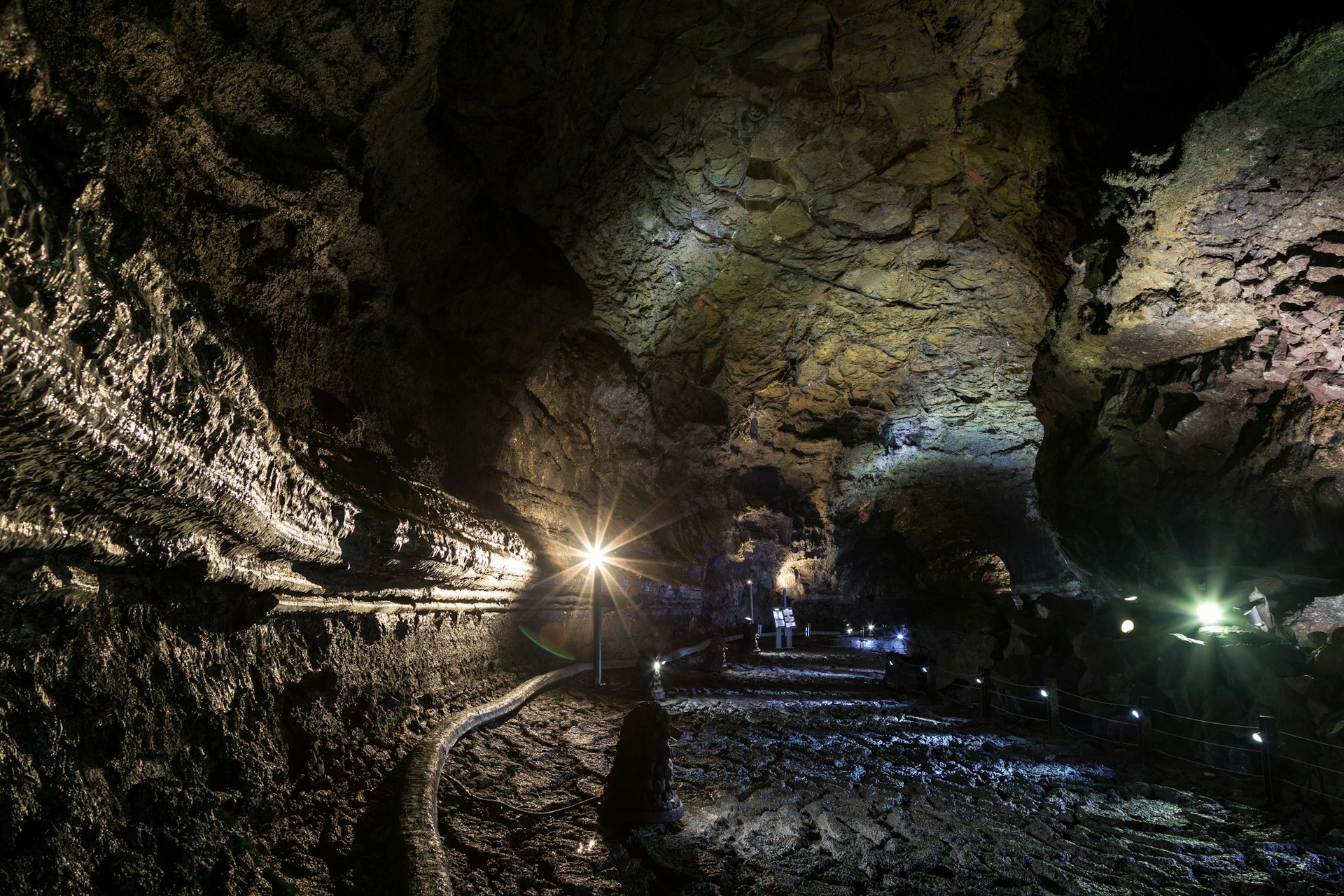 Inside the dark, lit and empty Manjanggul Lava Tube Cave on Jeju Island in South Korea.