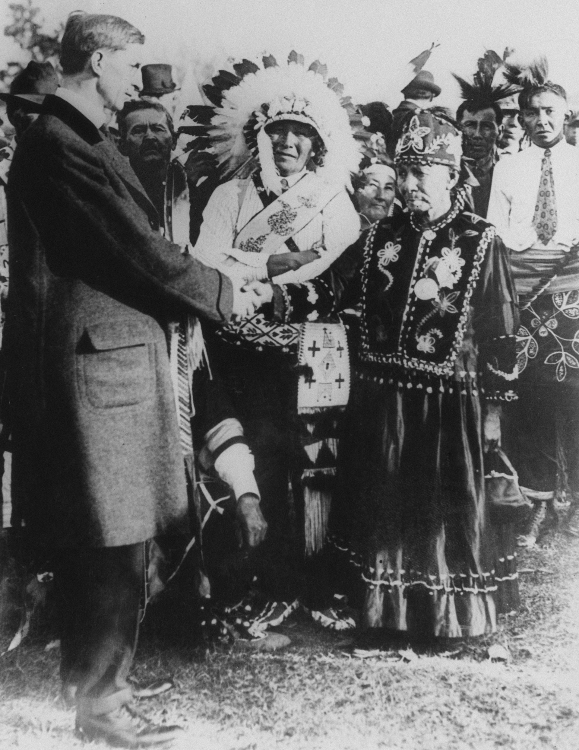 Irish politician and president of Dail Eireann, Eamon de Valera shakes hands with Native Americans during a visit to the USA, 1919