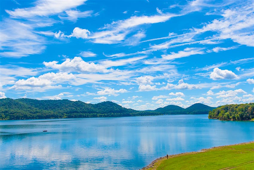 Cave Run Lake, Kentucky Summer view of Cave Run Lake with a forest on hillside shore and dramatic cloudscape sky in Kentucky