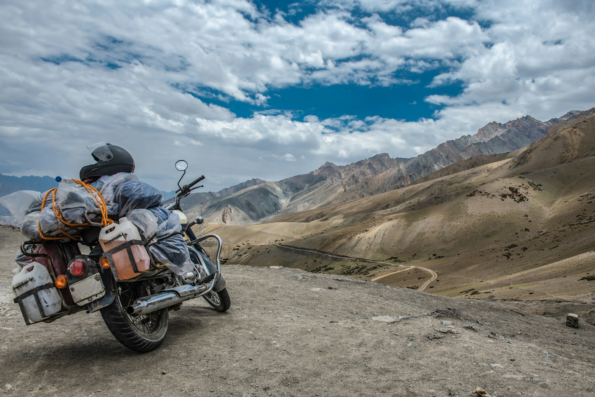A heavily loaded motorbike in the arid high-altitude mountains around Leh, India
