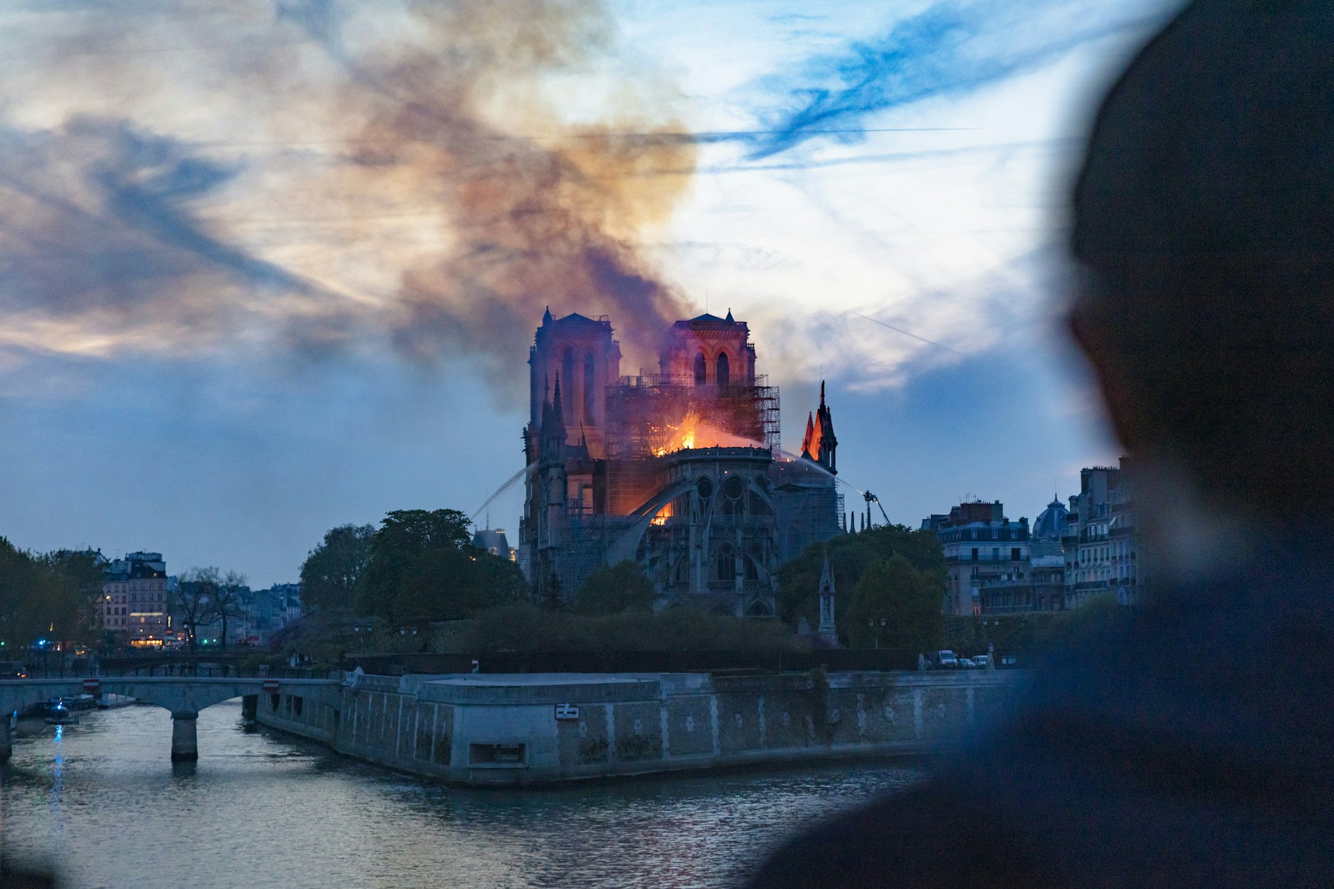 Man watching Notre-Dame de Paris fire from far, Paris, Ile-de-France, France
