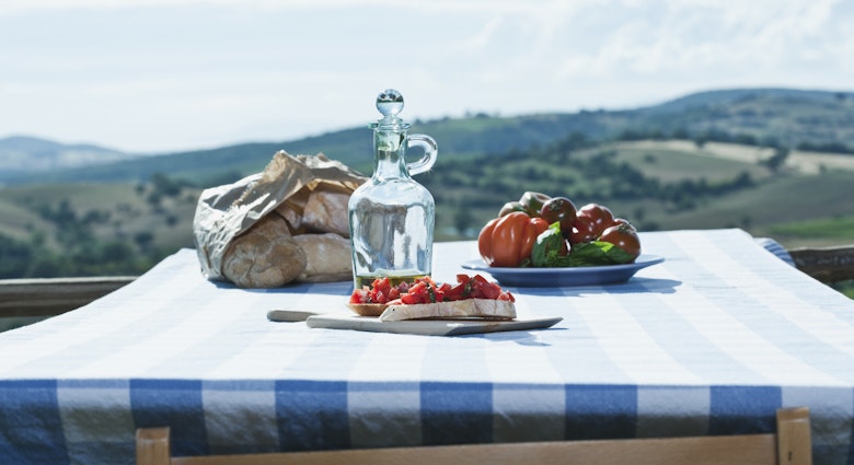 Italy, Tuscany, Magliano, Bruschetta, bread, tomatoes and olive oil on table
