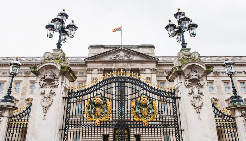 Gate at Buckingham Palace A large black wrought-iron gate outside a huge palace building